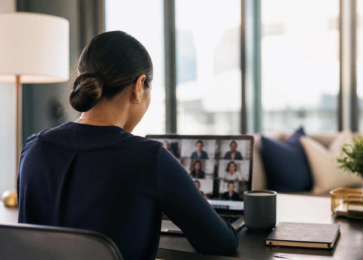 Filipino remote staffing team member on a video call in a bright modern workspace